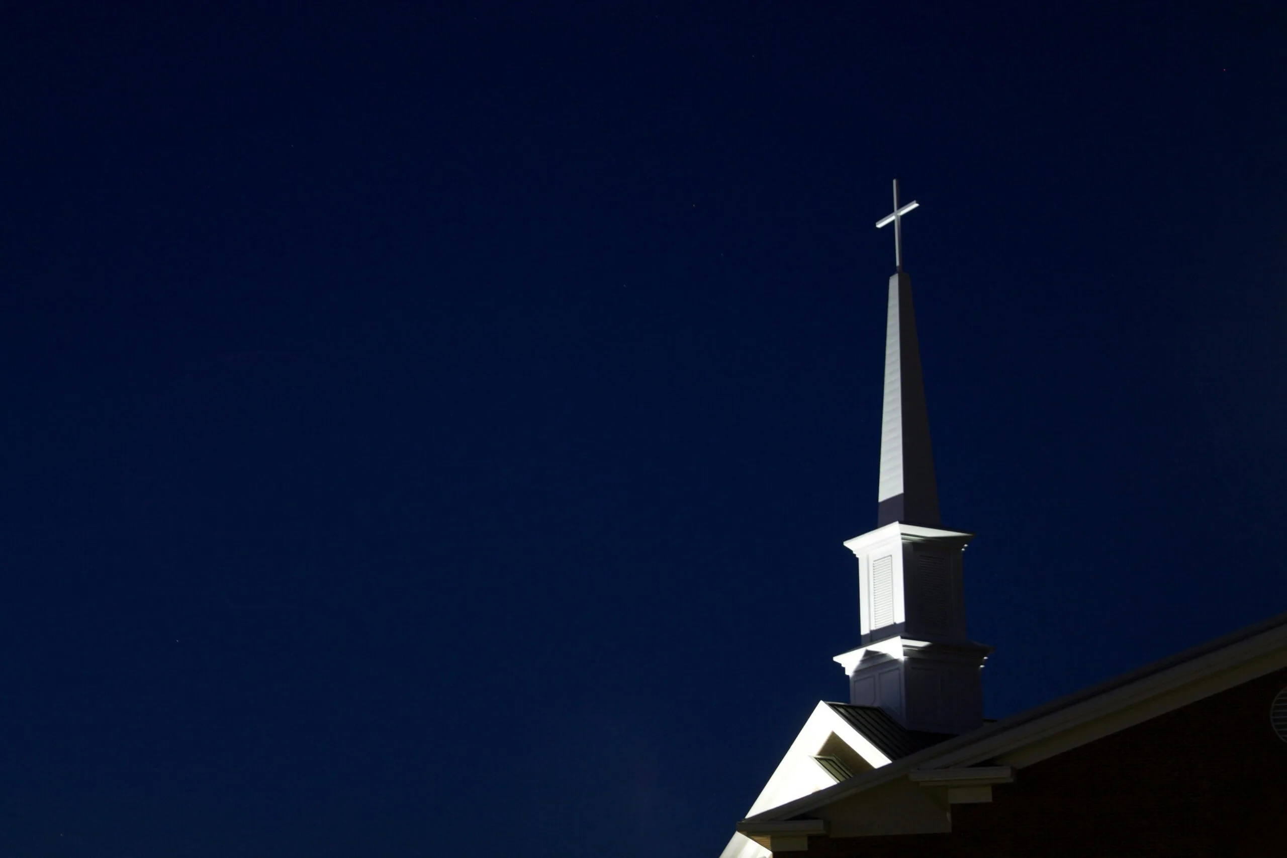 pexels-photo-257030-257030 Illuminated church steeple with cross at night. Perfect for religious and architectural themes.